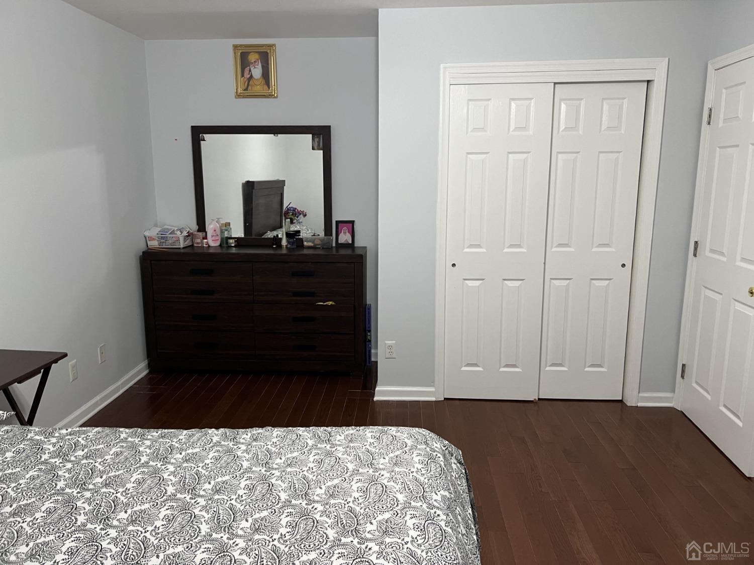 116 B Street Port Reading, NJ 07064 - Photo 17 of 30 a bed room with a bed and a mirror