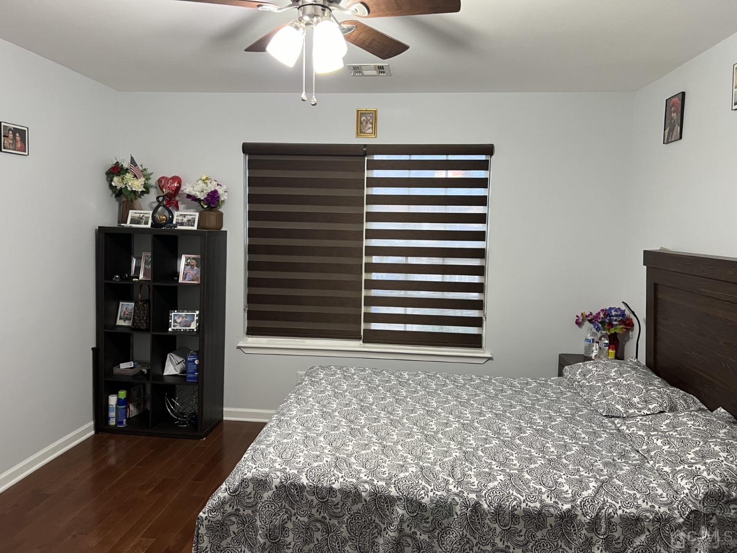 116 B Street Port Reading, NJ 07064 - Photo 18 of 30 a bedroom with a bed and a chandelier