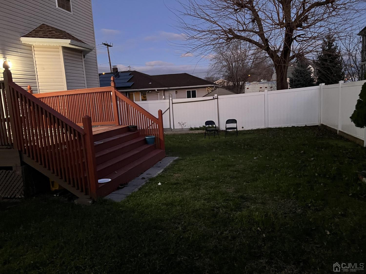 116 B Street Port Reading, NJ 07064 - Photo 28 of 30 a view of a backyard with sitting area and wooden fence