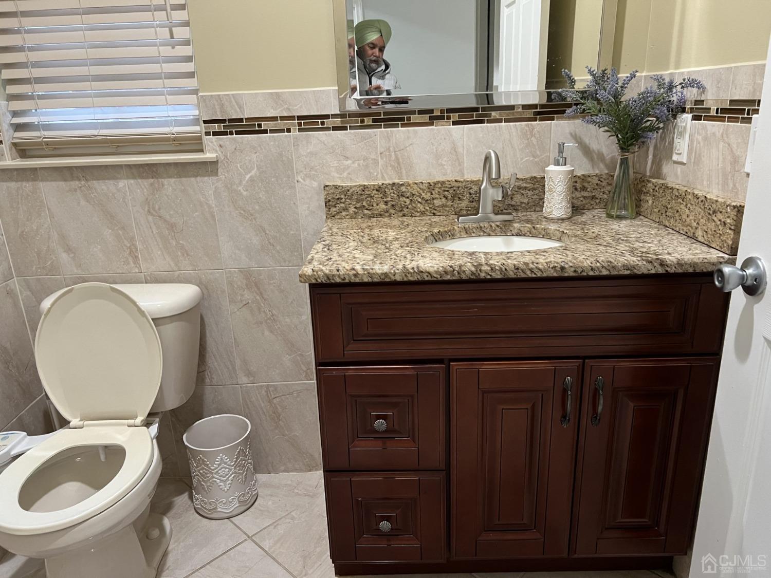 116 B Street Port Reading, NJ 07064 - Photo 6 of 30 a bathroom with a granite countertop toilet sink and mirror