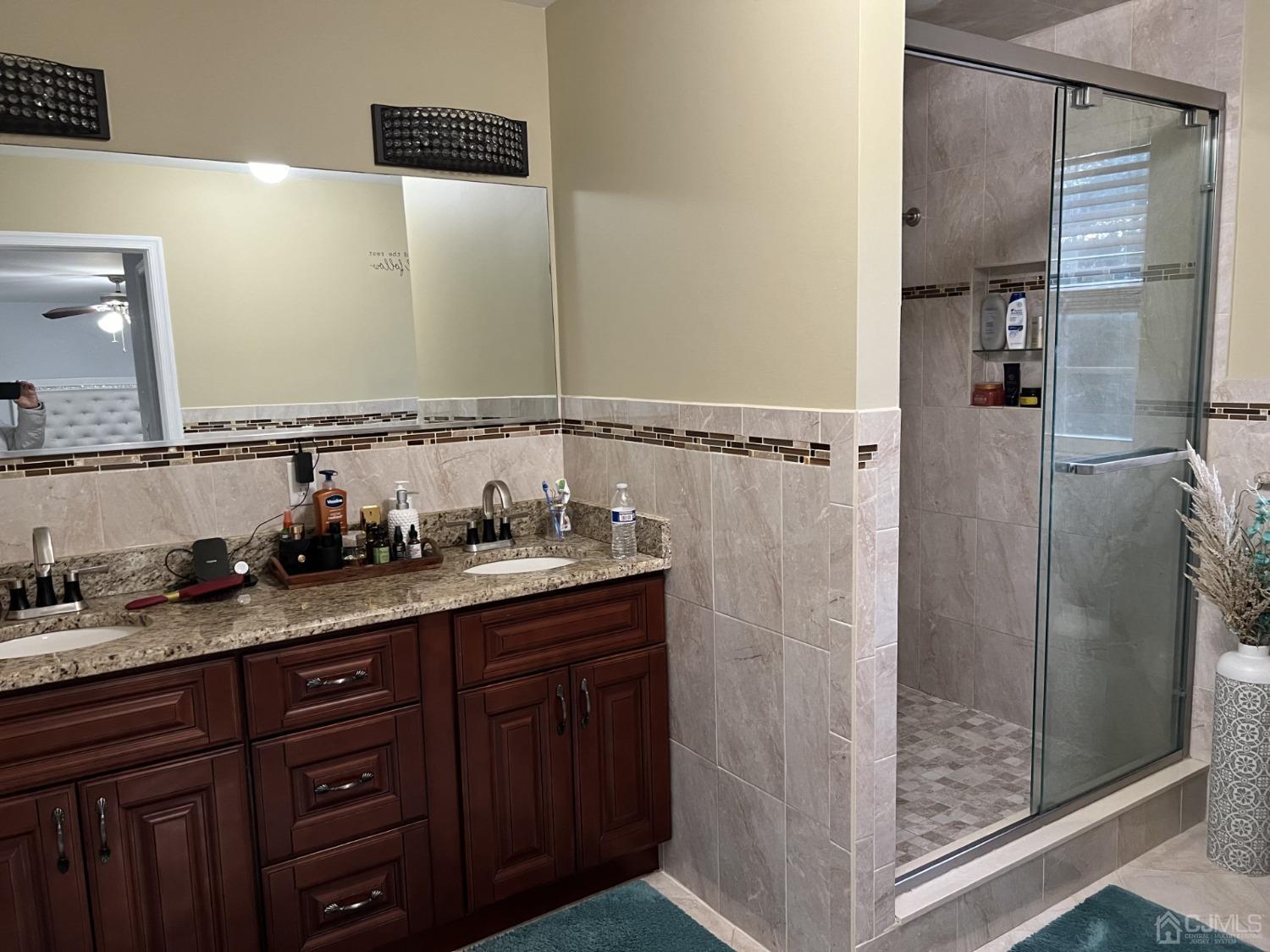 116 B Street Port Reading, NJ 07064 - Photo 9 of 30 a bathroom with a granite countertop sink and a mirror