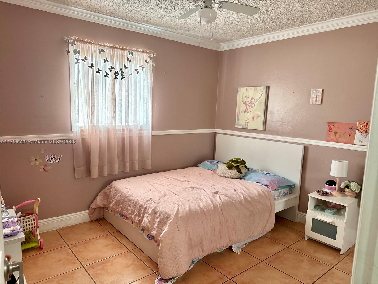 13065 Southwest 263rd Terrace Homestead, FL 33032 - Photo 12 of 19 a bedroom with a bed and a window