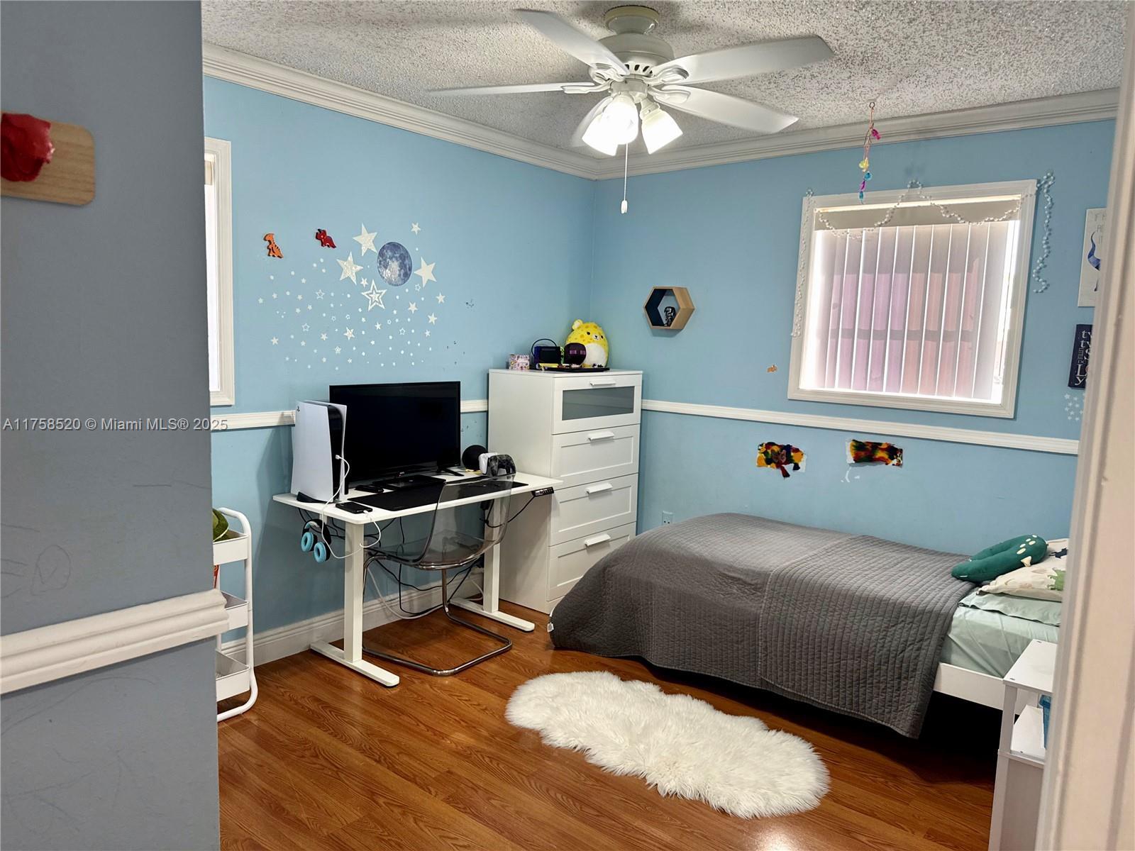 13065 Southwest 263rd Terrace Homestead, FL 33032 - Photo 13 of 19 a bedroom with a bed and a flat screen tv
