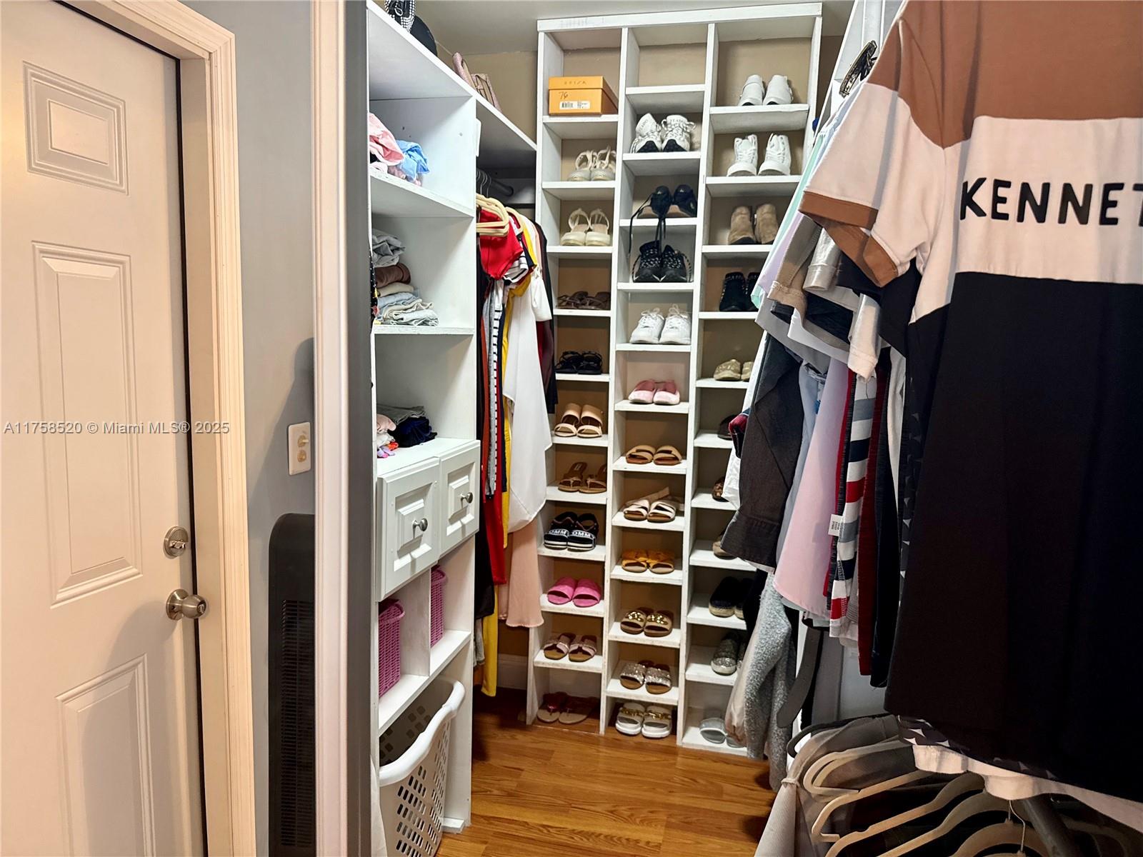 13065 Southwest 263rd Terrace Homestead, FL 33032 - Photo 15 of 19 a view of walk in closet with clothes and shoes