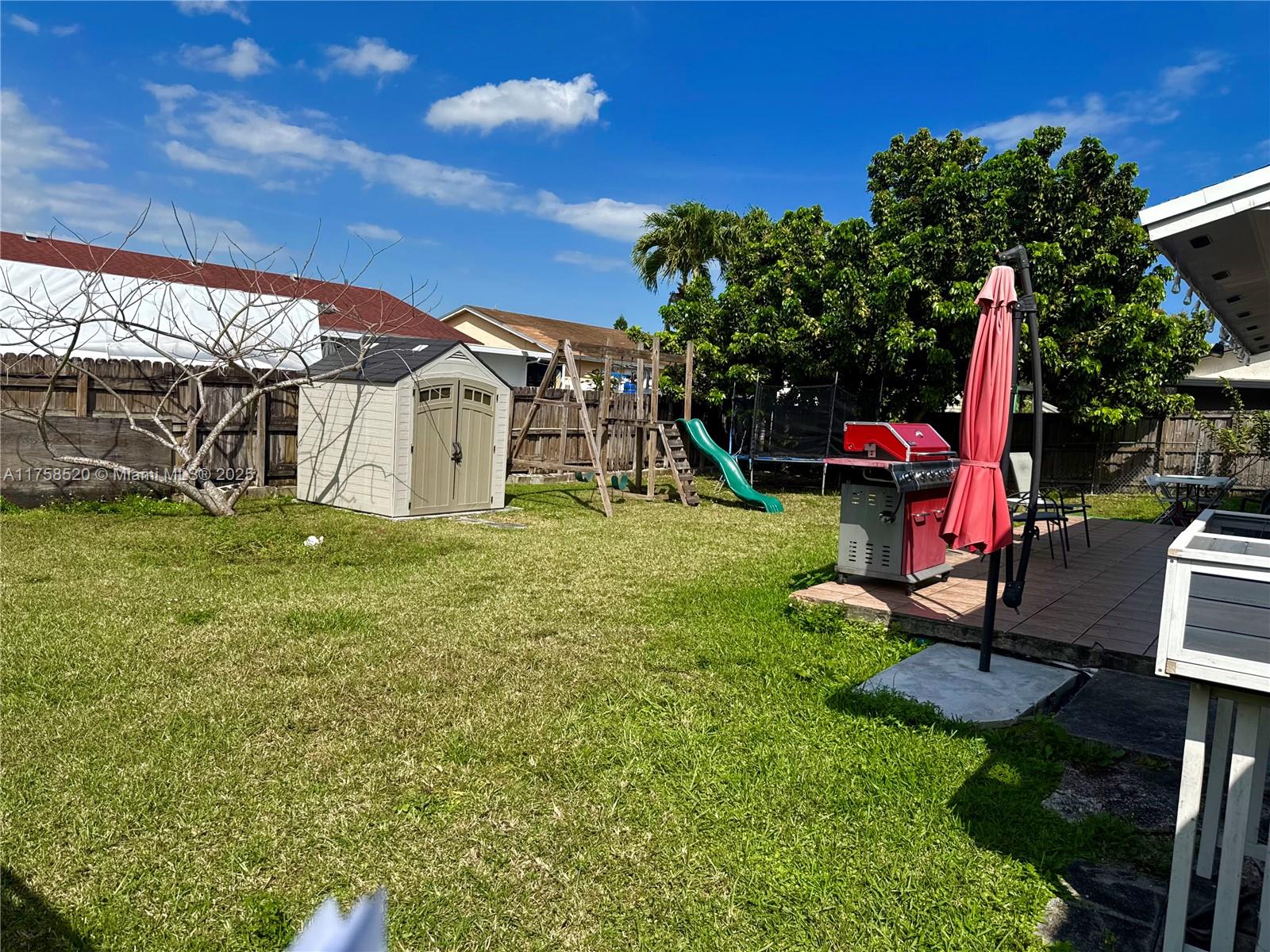13065 Southwest 263rd Terrace Homestead, FL 33032 - Photo 16 of 19 a view of yard with swimming pool and green space