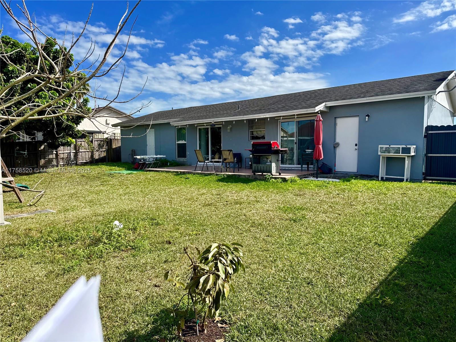 13065 Southwest 263rd Terrace Homestead, FL 33032 - Photo 17 of 19 a view of a house with a big yard and sitting area