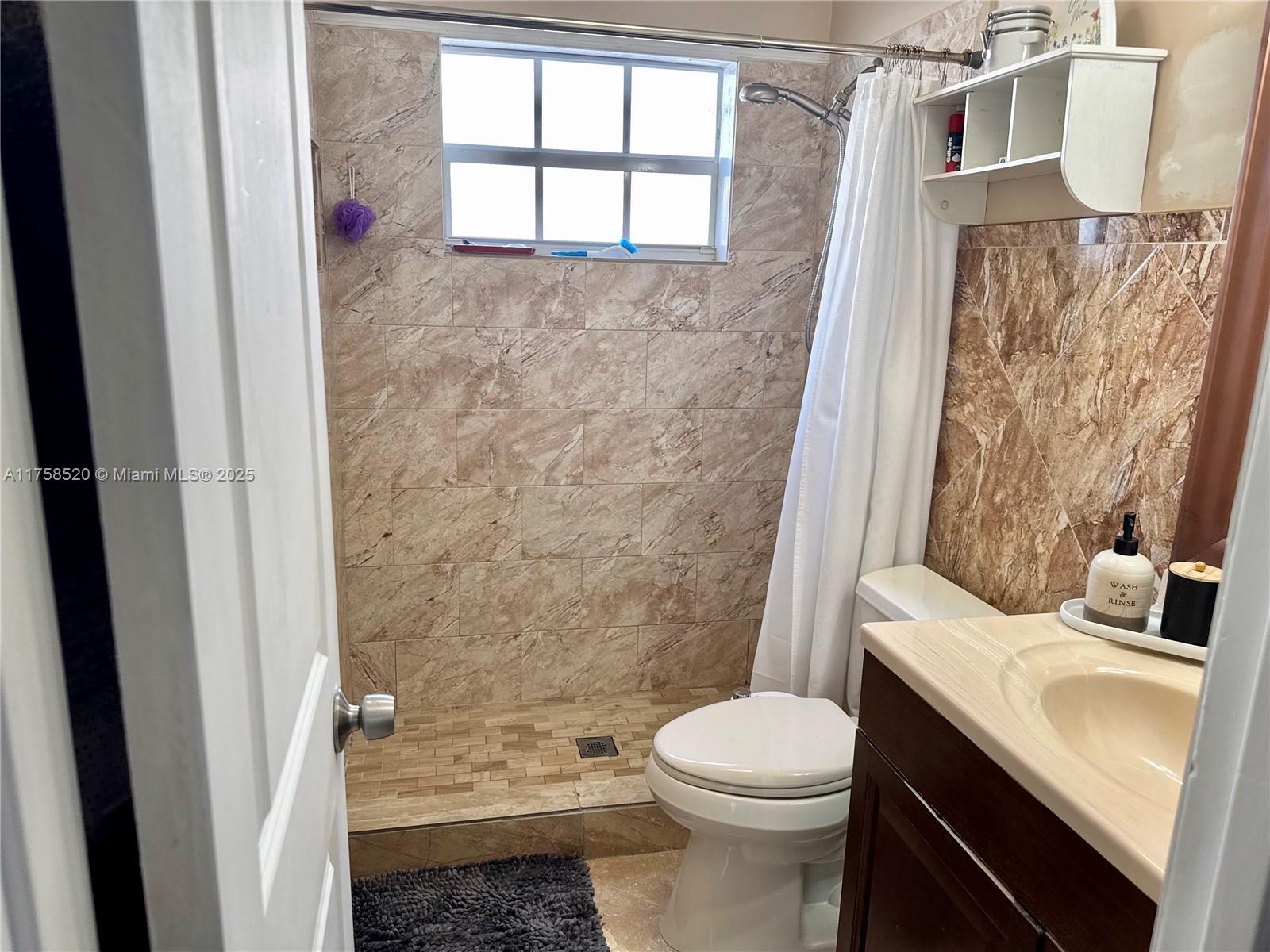 13065 Southwest 263rd Terrace Homestead, FL 33032 - Photo 4 of 19 a bathroom with a sink toilet and shower