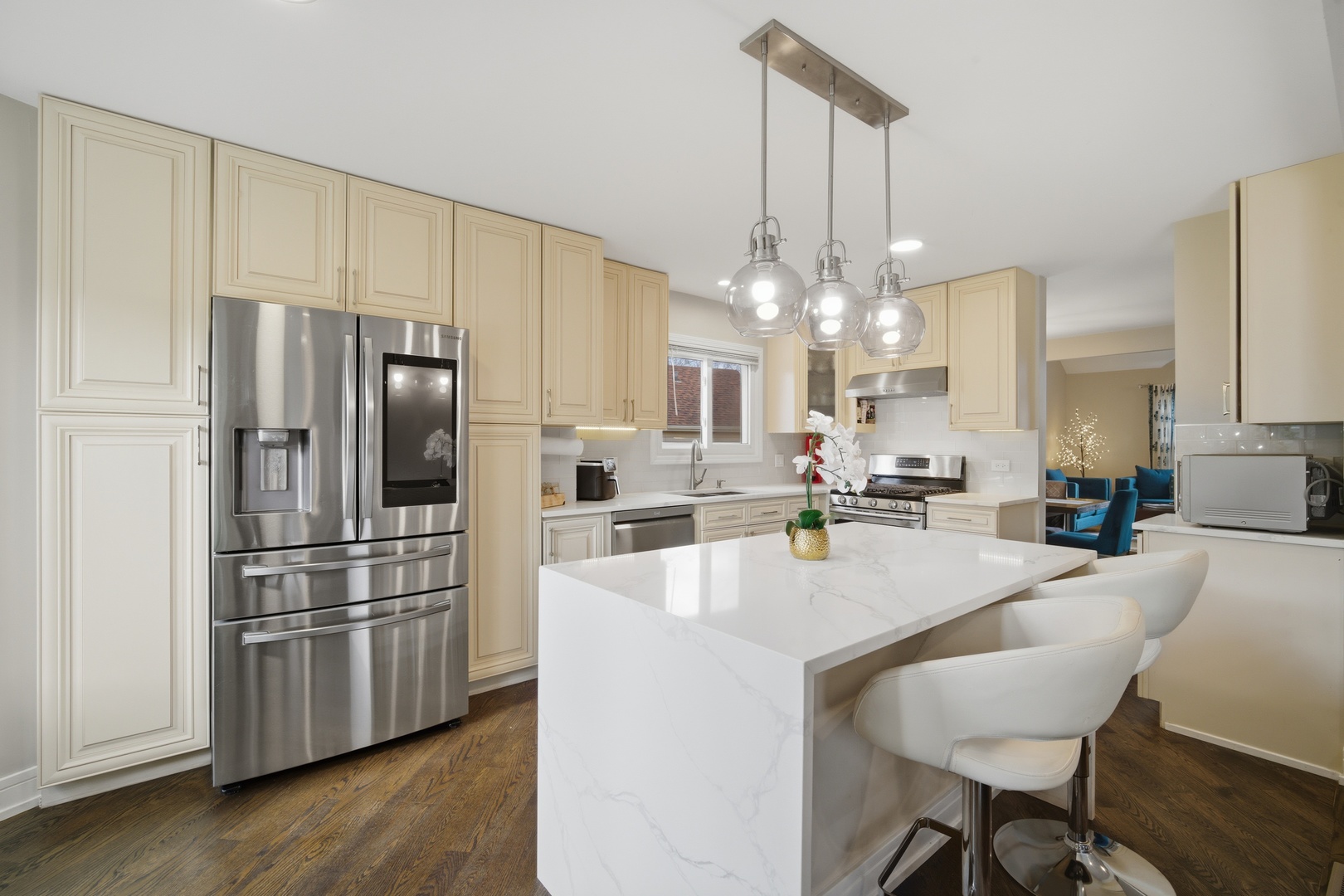 2936 Sandalwood Road Buffalo Grove, IL 60089 - Photo 11 of 40 a kitchen with stainless steel appliances a dining table chairs stove and refrigerator