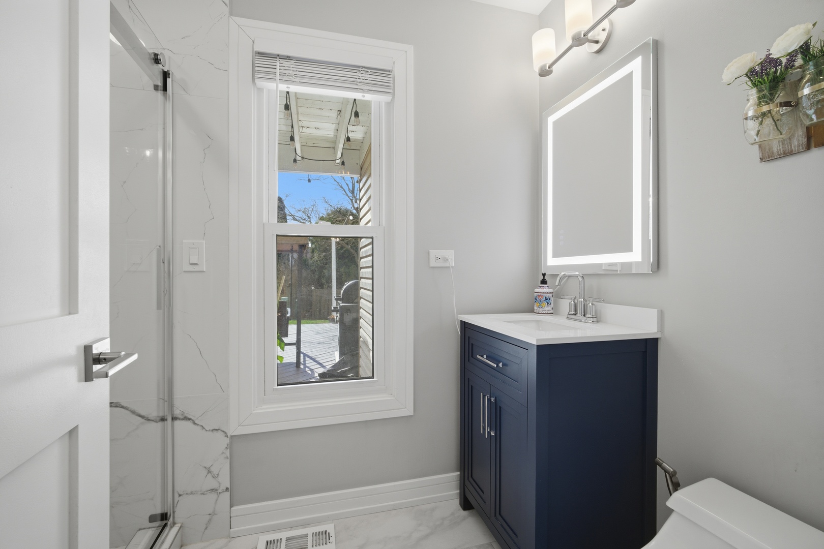 2936 Sandalwood Road Buffalo Grove, IL 60089 - Photo 16 of 40 a bathroom with a sink a toilet and shower