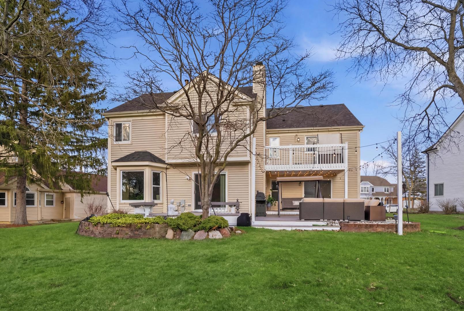 2936 Sandalwood Road Buffalo Grove, IL 60089 - Photo 31 of 40 a front view of a house with a garden and trees