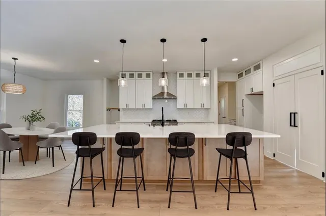 a view of kitchen with dining area refrigerator and wooden floor