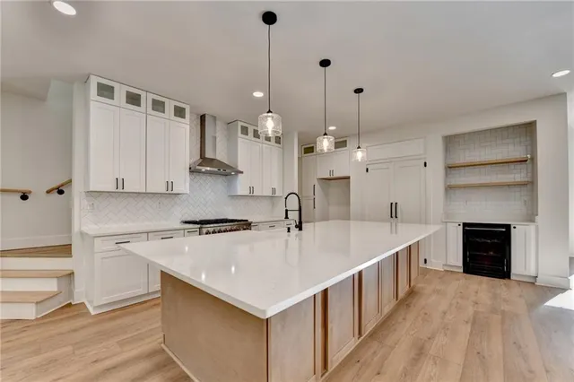a large kitchen with a stove and a kitchen island