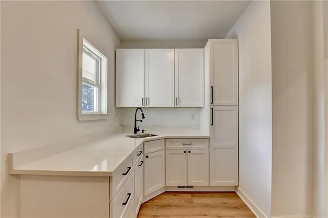 a kitchen with a sink cabinets and window