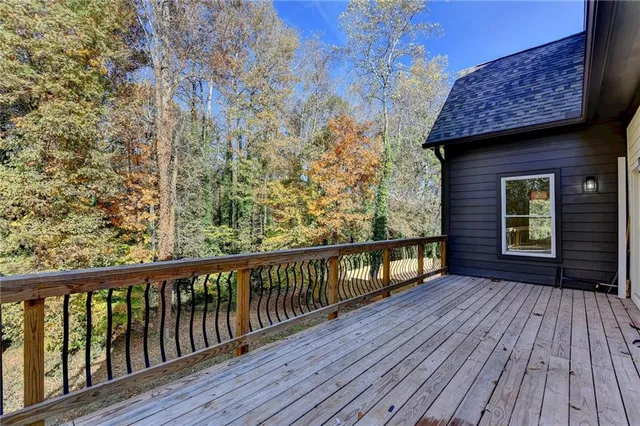 a view of a balcony with wooden floor and fence