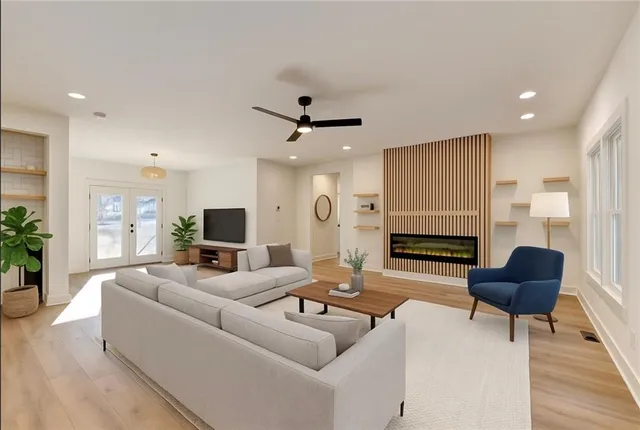 a living room with fireplace furniture and a wooden floor