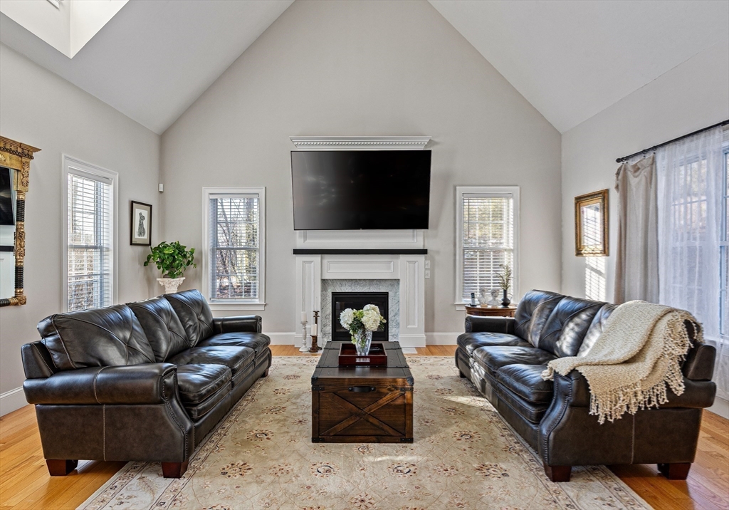 7 Jewell Crossing Mendon, MA 01756 - Photo 16 of 42 a living room with furniture fireplace and flat screen tv