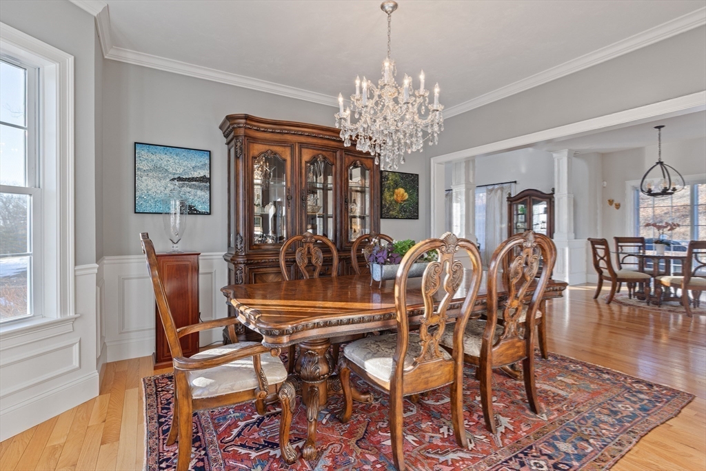 7 Jewell Crossing Mendon, MA 01756 - Photo 18 of 42 a view of a dining room with furniture a chandelier and wooden floor