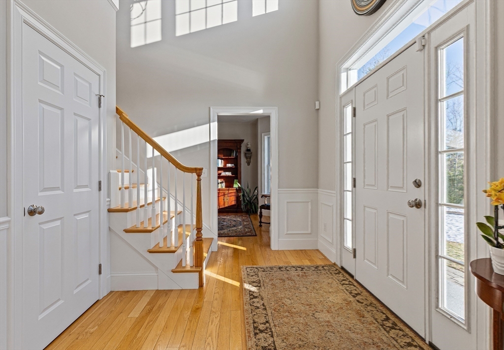 7 Jewell Crossing Mendon, MA 01756 - Photo 19 of 42 a view of an entryway with wooden floor and stairs