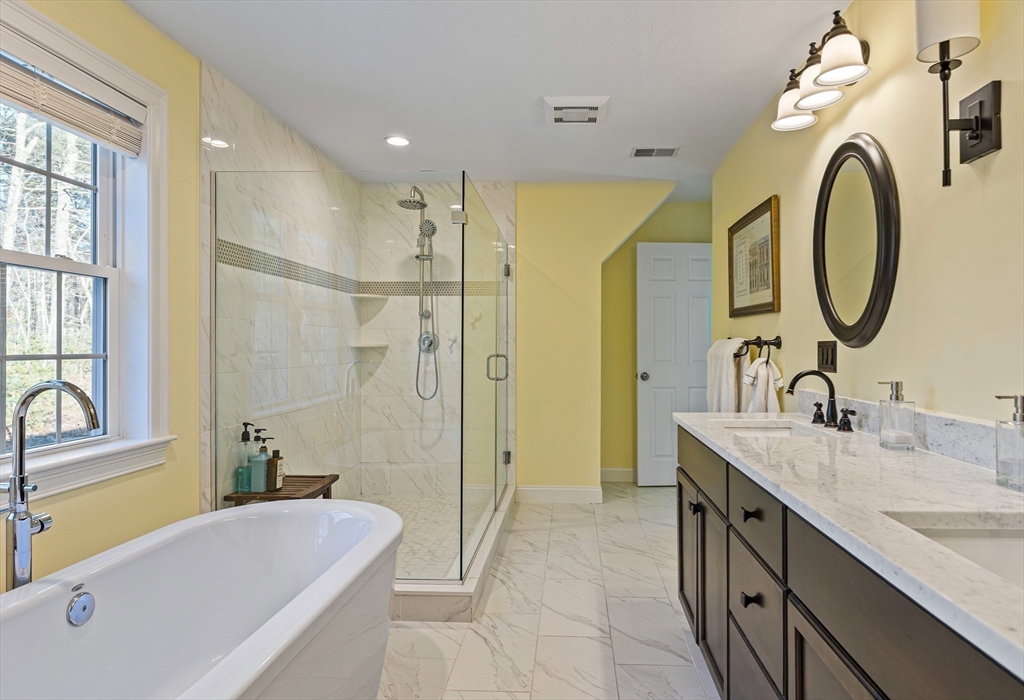 7 Jewell Crossing Mendon, MA 01756 - Photo 24 of 42 a bathroom with a granite countertop sink mirror bathtub and shower