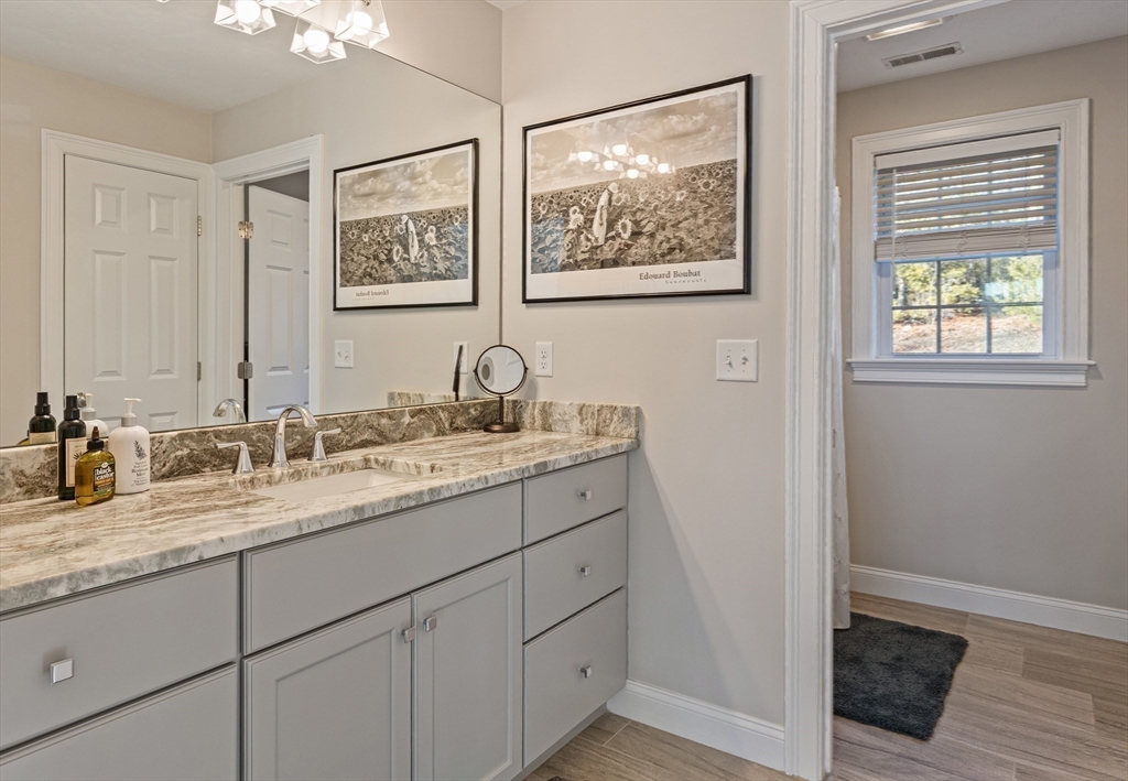 7 Jewell Crossing Mendon, MA 01756 - Photo 27 of 42 a bathroom with a granite countertop sink mirror and a