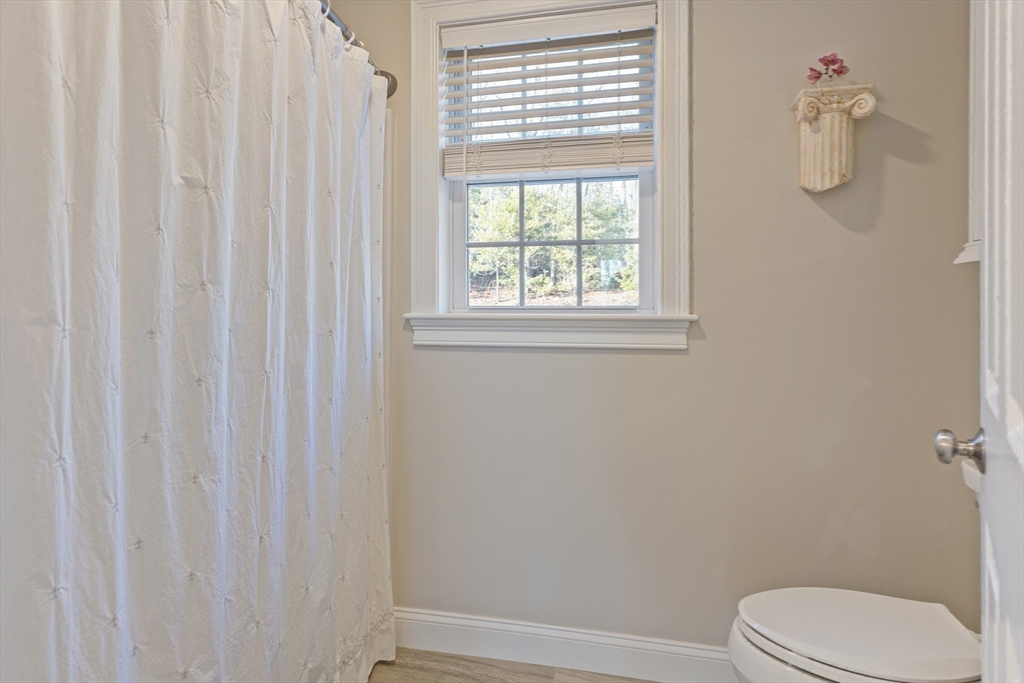 7 Jewell Crossing Mendon, MA 01756 - Photo 28 of 42 a white toilet sitting next to a window