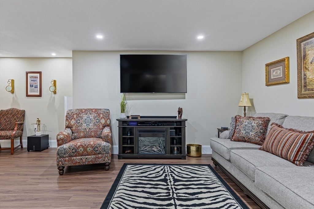 7 Jewell Crossing Mendon, MA 01756 - Photo 32 of 42 a living room with furniture and a flat screen tv