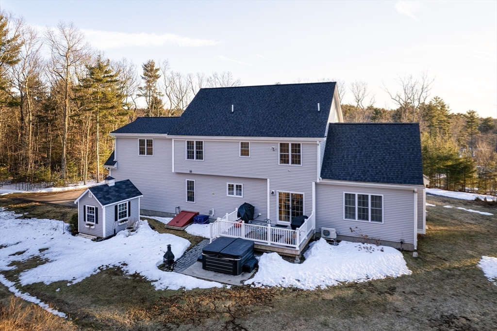 7 Jewell Crossing Mendon, MA 01756 - Photo 36 of 42 a backyard of a house with fire pit and outdoor seating