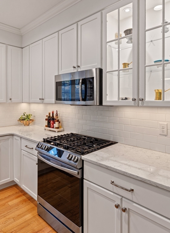 7 Jewell Crossing Mendon, MA 01756 - Photo 7 of 42 a kitchen with granite countertop white cabinets stainless steel appliances and a sink