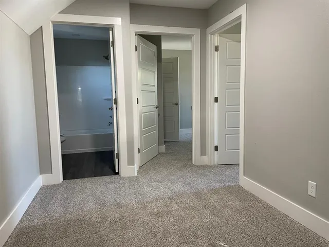 an empty room with closet and a bathroom