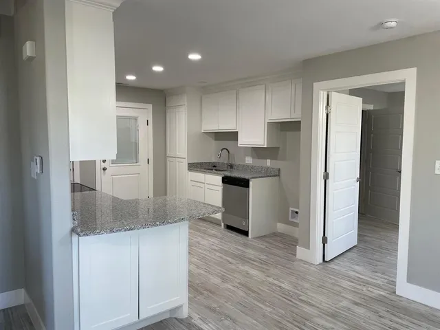 a kitchen with stainless steel appliances granite countertop a refrigerator and a stove top oven
