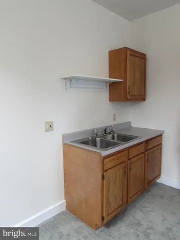 a kitchen with stainless steel appliances a stove a sink and a microwave