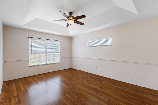 a view of a room with wooden floor and natural light