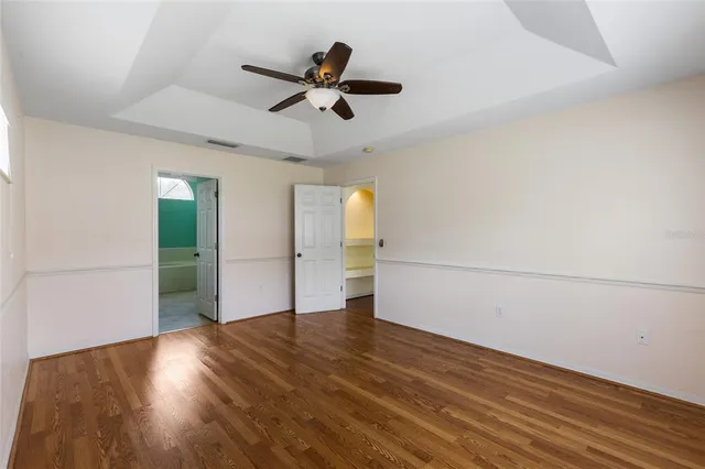 a view of empty room with wooden floor