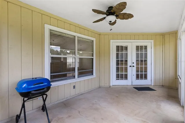 a view of a room with wooden floor and windows