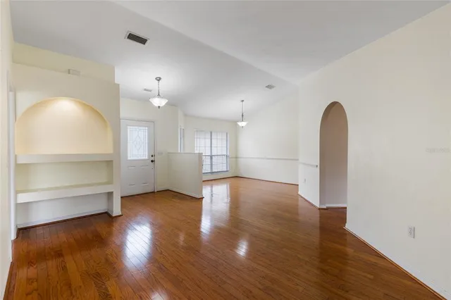 a view of a room with wooden floor and windows