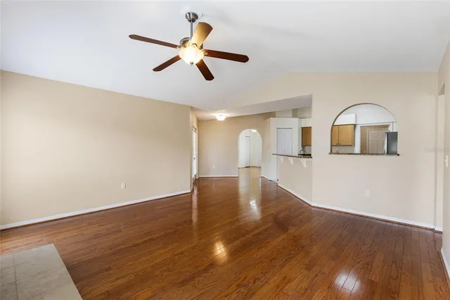 a view of a kitchen with wooden floor and a ceiling fan