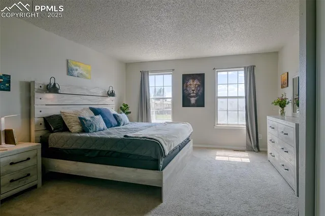 a spacious bedroom with a bed and a window