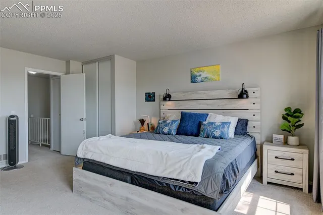 a bedroom with a bed and a potted plant