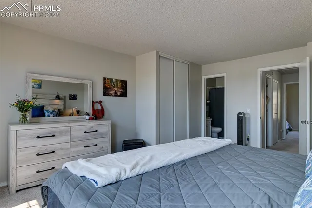 a bedroom with a bed and a mirror