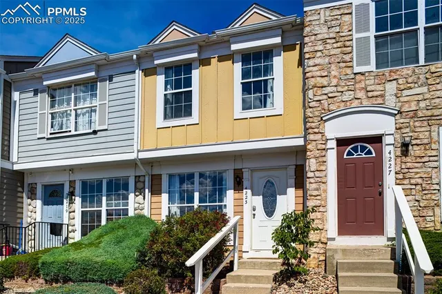 a front view of a house with plants
