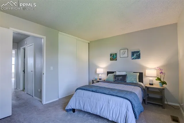 a bedroom with a bed and a night stand