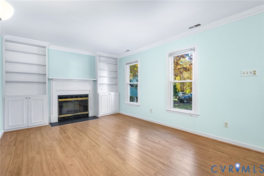 2411 Arrowood Road Midlothian, VA 23112 - Photo 5 of 34 an empty room with windows and fireplace