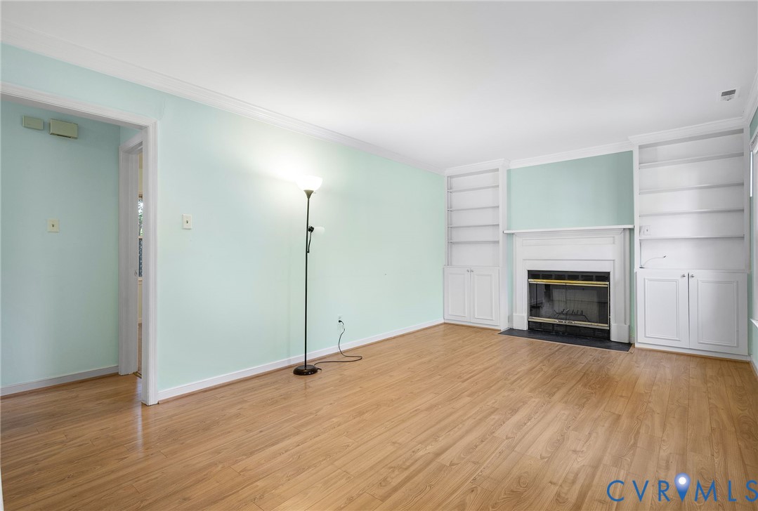 2411 Arrowood Road Midlothian, VA 23112 - Photo 6 of 34 a view of an empty room with wooden floor fireplace and a window