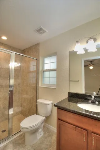 a bathroom with a shower a toilet and a sink
