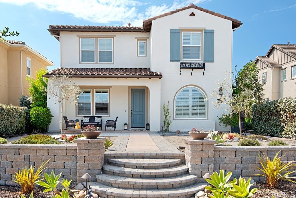 a front view of a house with outdoor seating