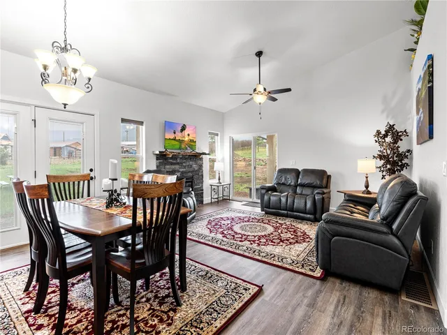 a view of a dining room with furniture a chandelier and wooden floor