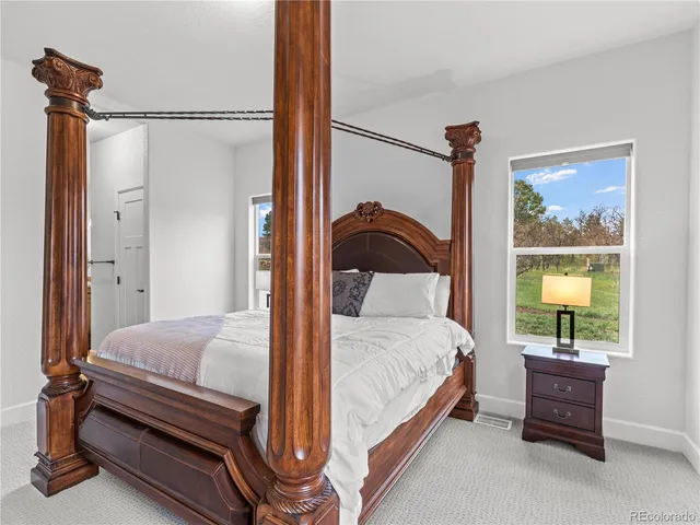 a bedroom with a bed and a mirror