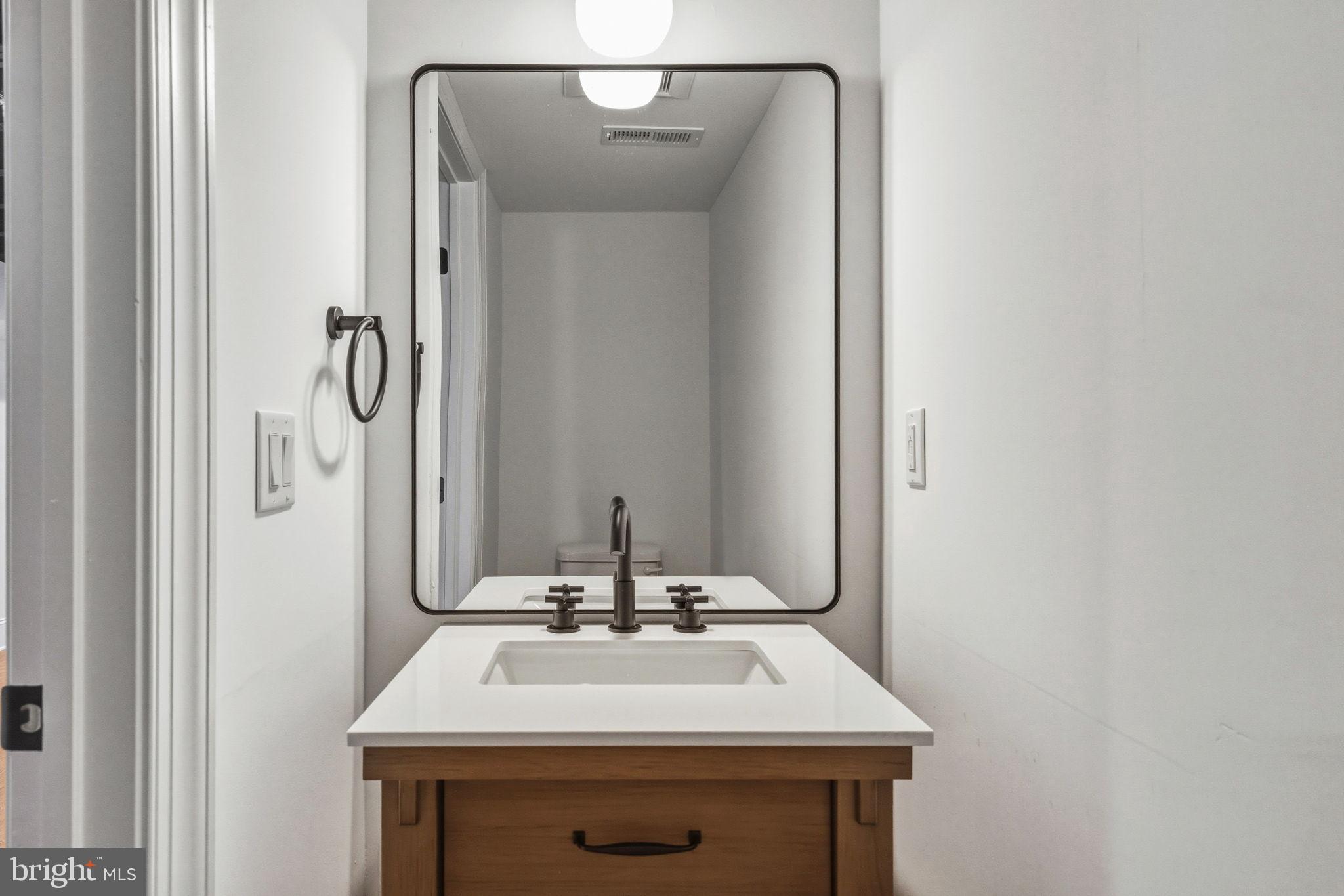 1635 South 5th Street Philadelphia, PA 19148 - Photo 59 of 60 a bathroom with a sink and a mirror