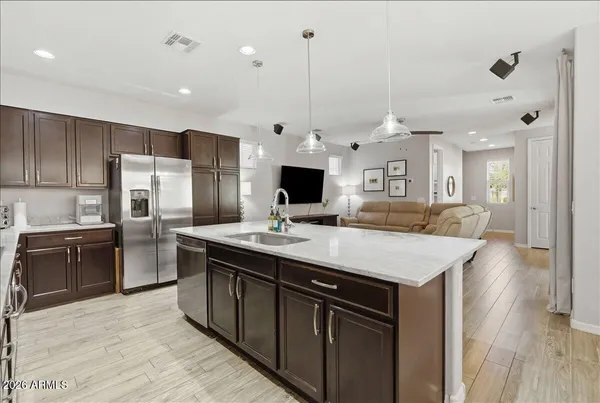 a large kitchen with kitchen island a sink table and chairs