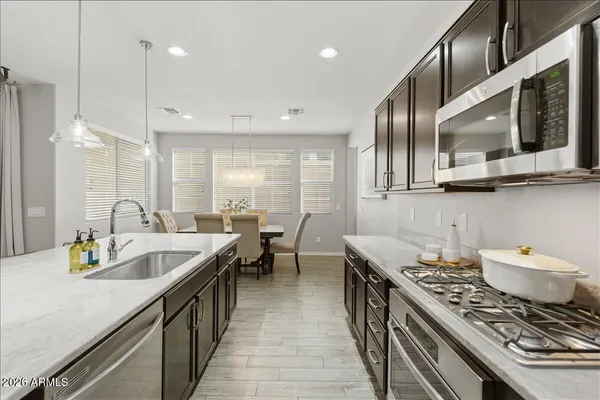 a kitchen with lots of counter space dining table and stainless steel appliances